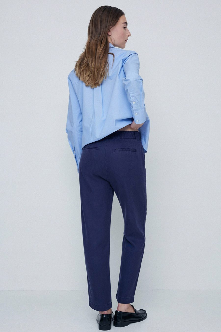 Navy straight leg trouser with elastic back and button and zip closure back pockets. 