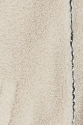 Close-up of a textured beige fabric with a zipper detail