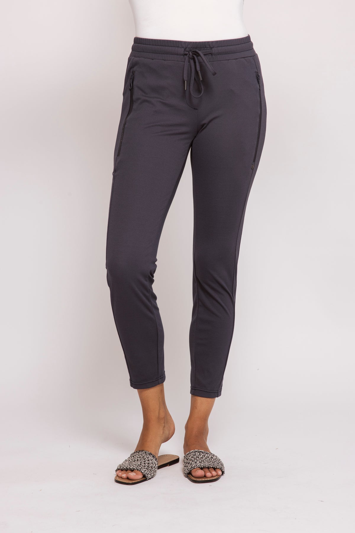 Blue  jogger pants worn by a person on a white background