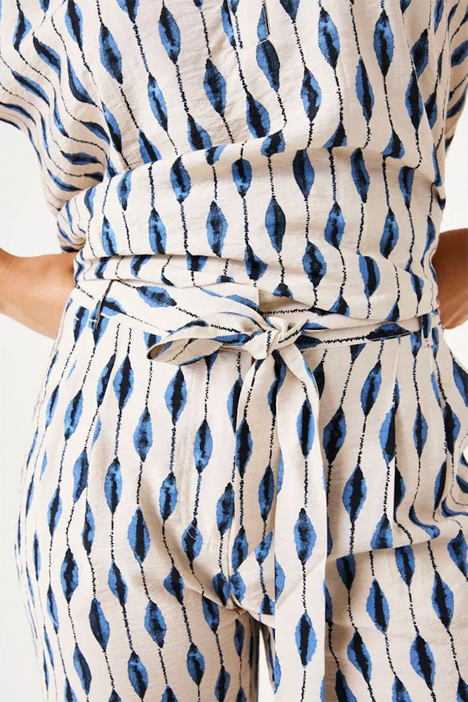 Blue and white patterned dress with a tie waist on a white background