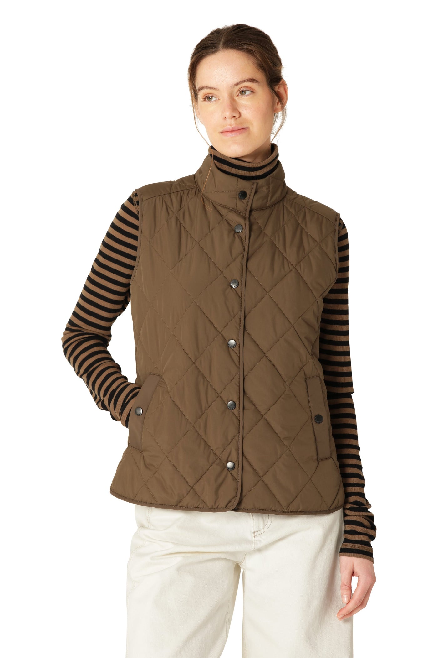 Woman wearing a brown quilted vest over a striped shirt on a white background