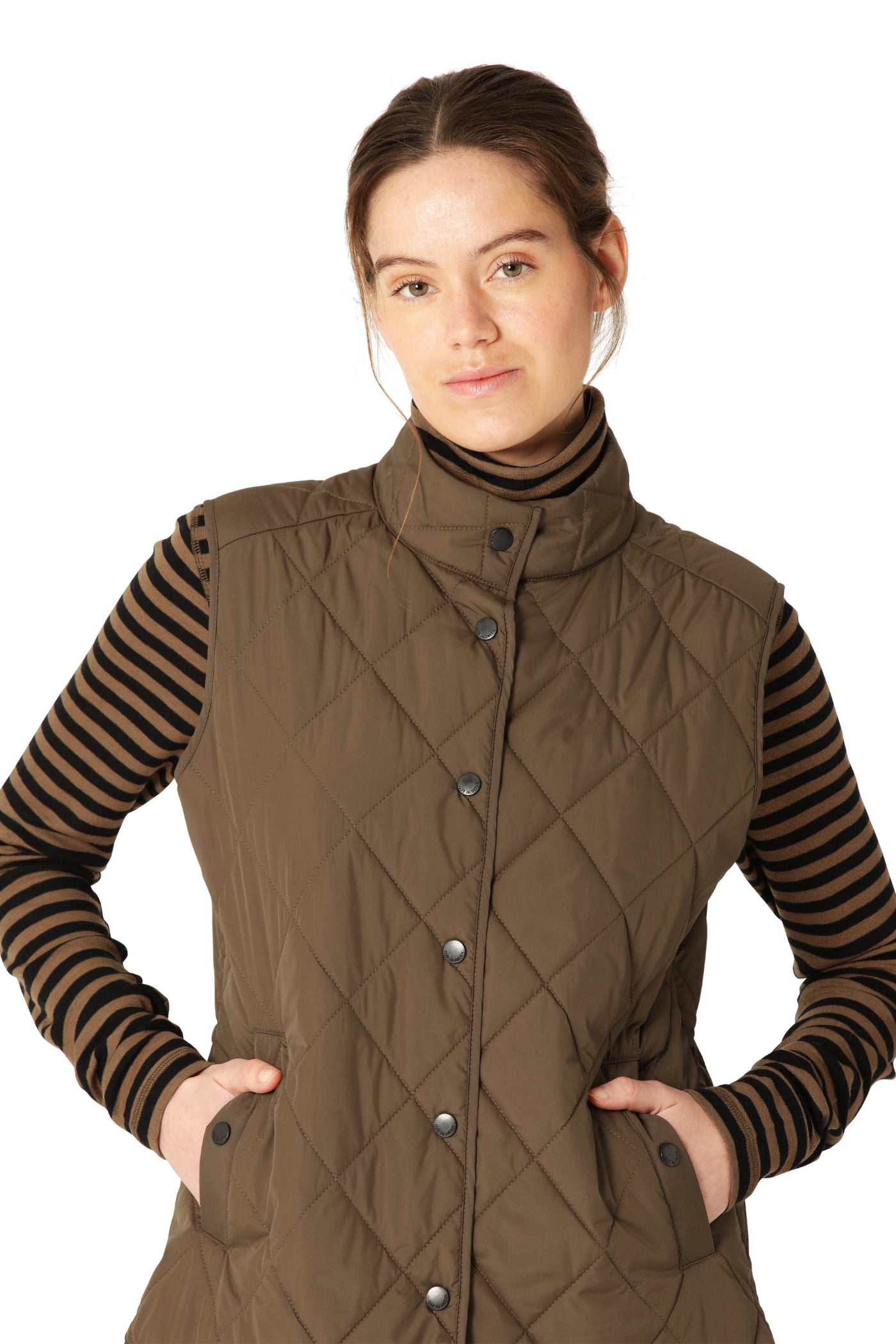 Woman wearing a brown quilted vest over a striped shirt on a white background