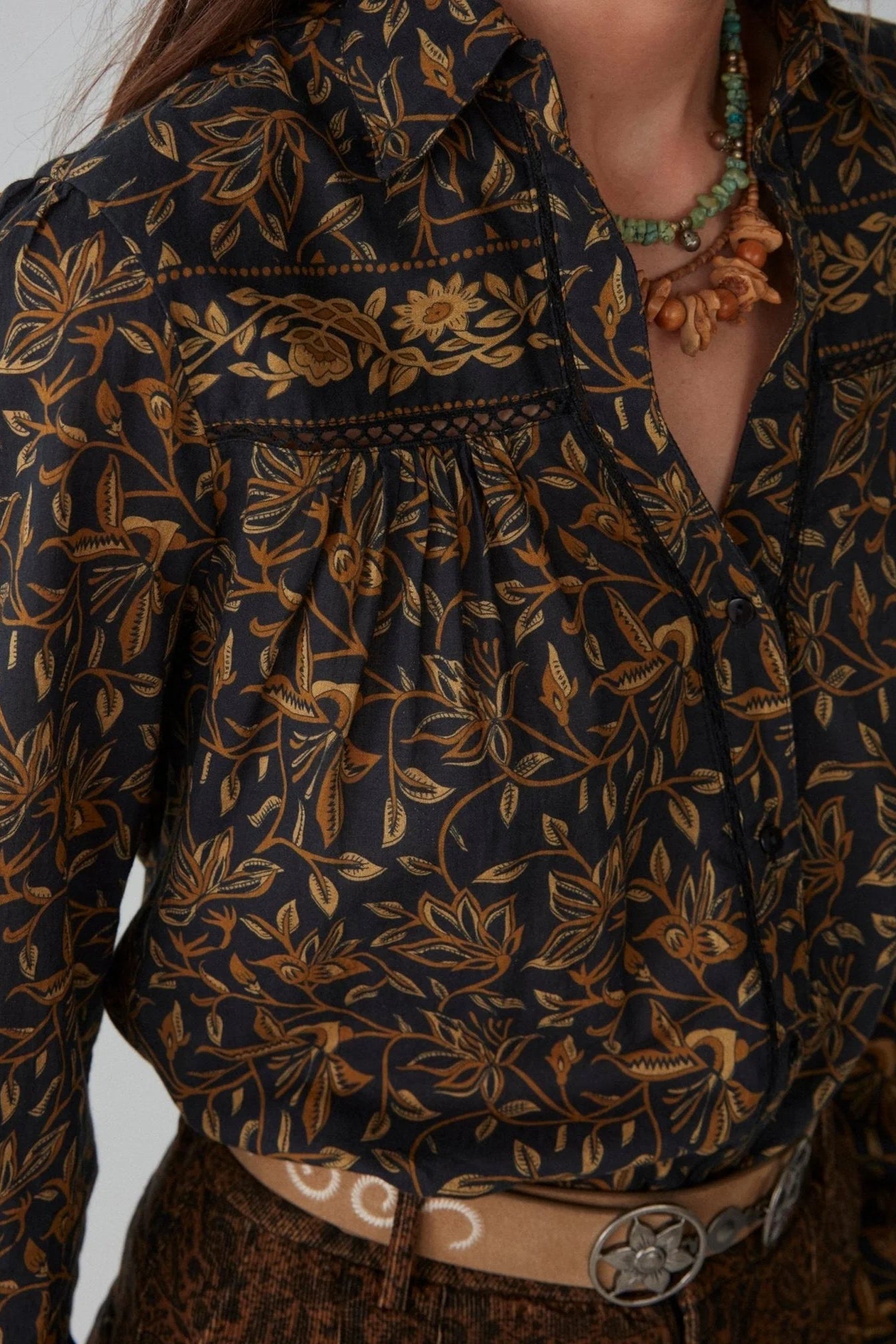 Shirt with a rich, hand-drawn floral print in deep golden and earthy tone
