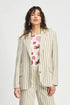Woman wearing a striped suit with a floral top on a white background