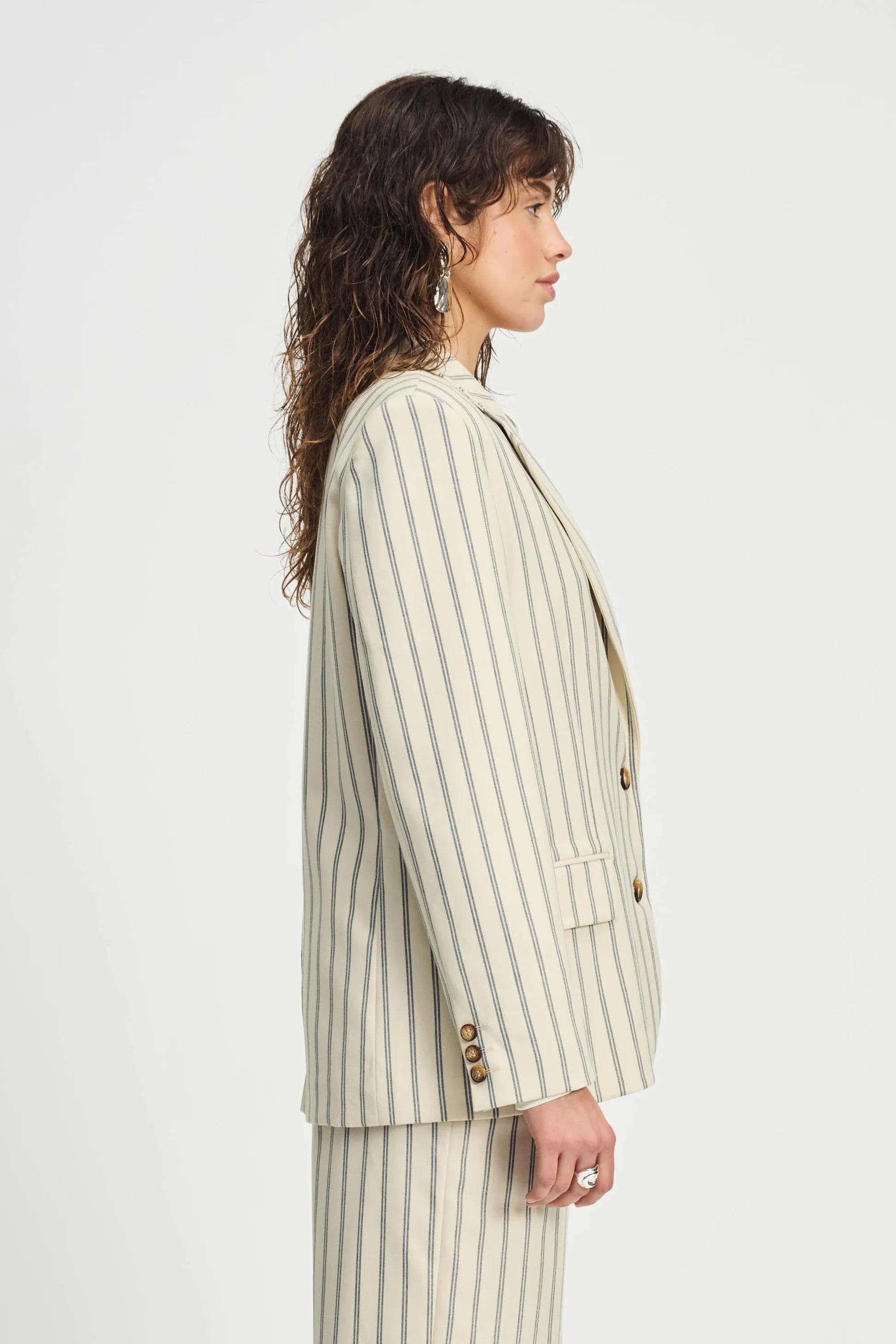Woman wearing a striped suit on a white background