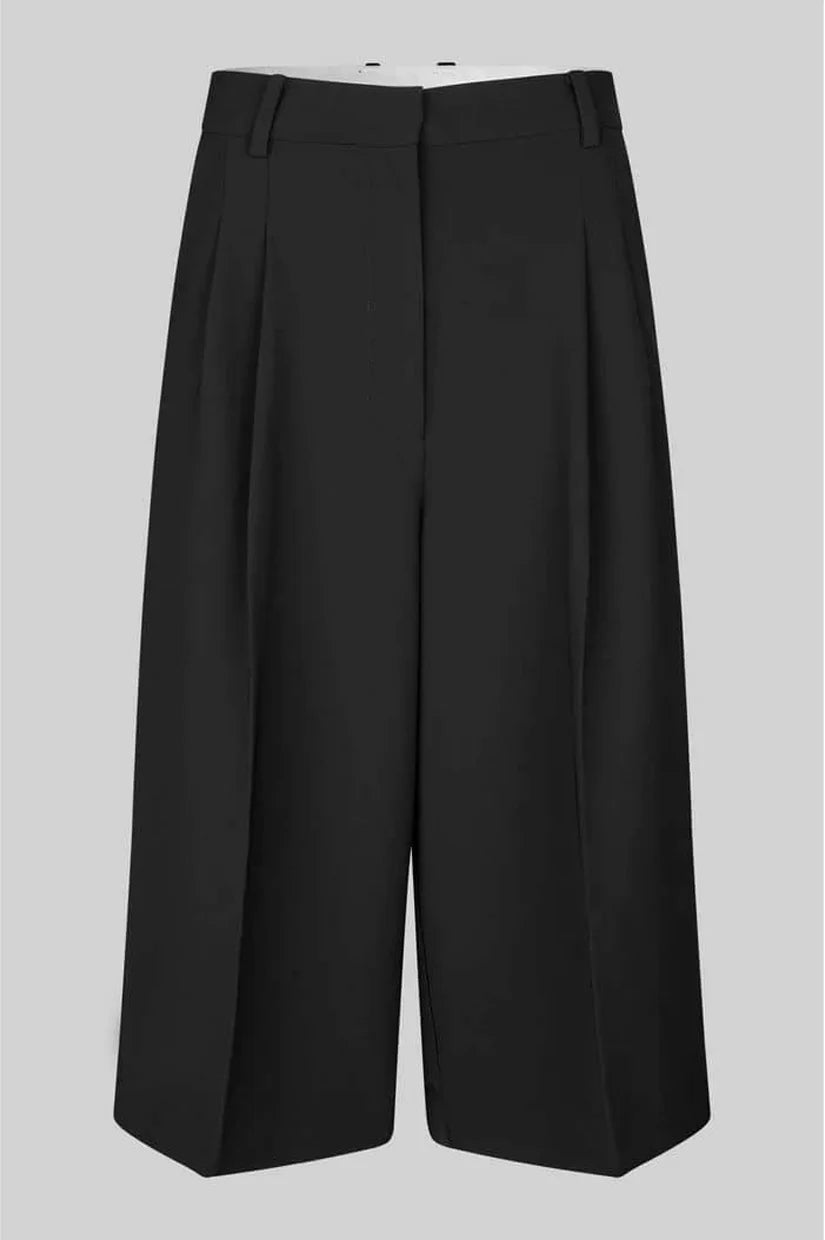 Black wide-leg bermuda shorts with front pleats, shown flat against a solid grey background.