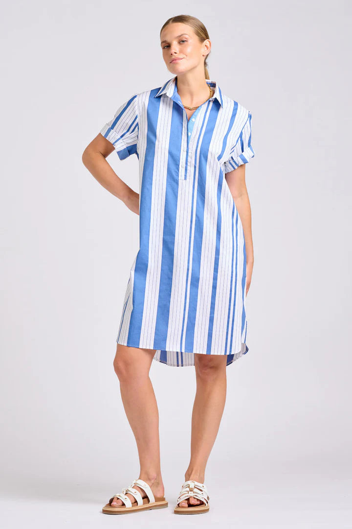 Woman wearing a blue and white striped dress on a plain background