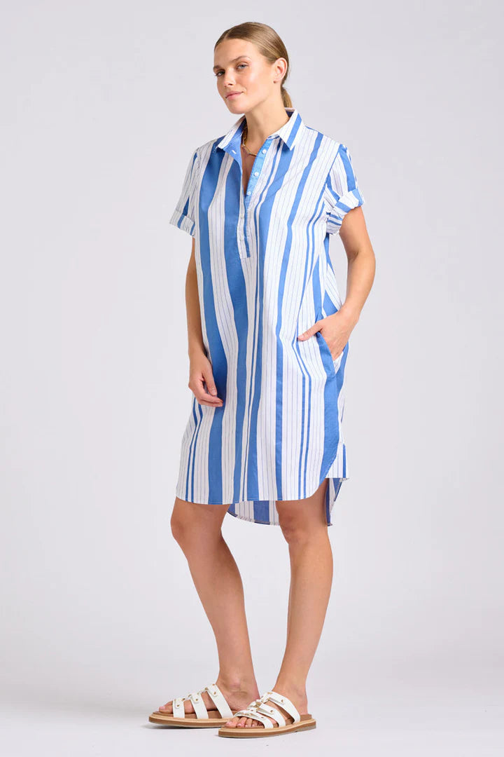 Woman wearing a blue and white striped dress on a plain background
