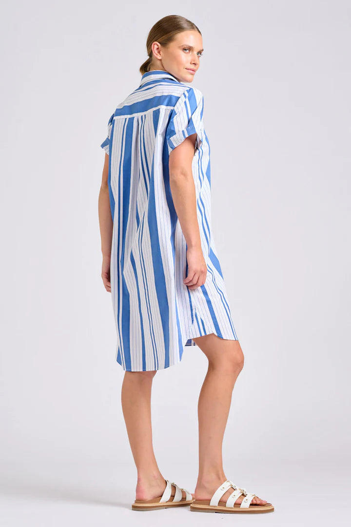 Woman wearing a blue and white striped dress on a plain background