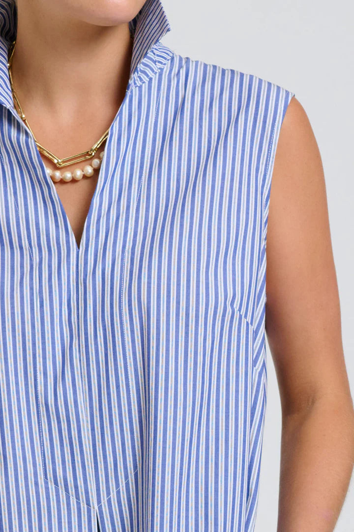 Close up of women wearing a sleeveless navy and light blue stripe shiest dress on a white back ground. 