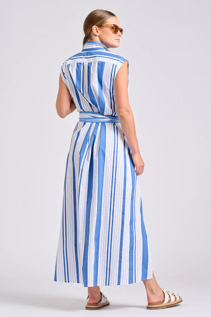 Woman wearing a blue and white striped dress on a plain background