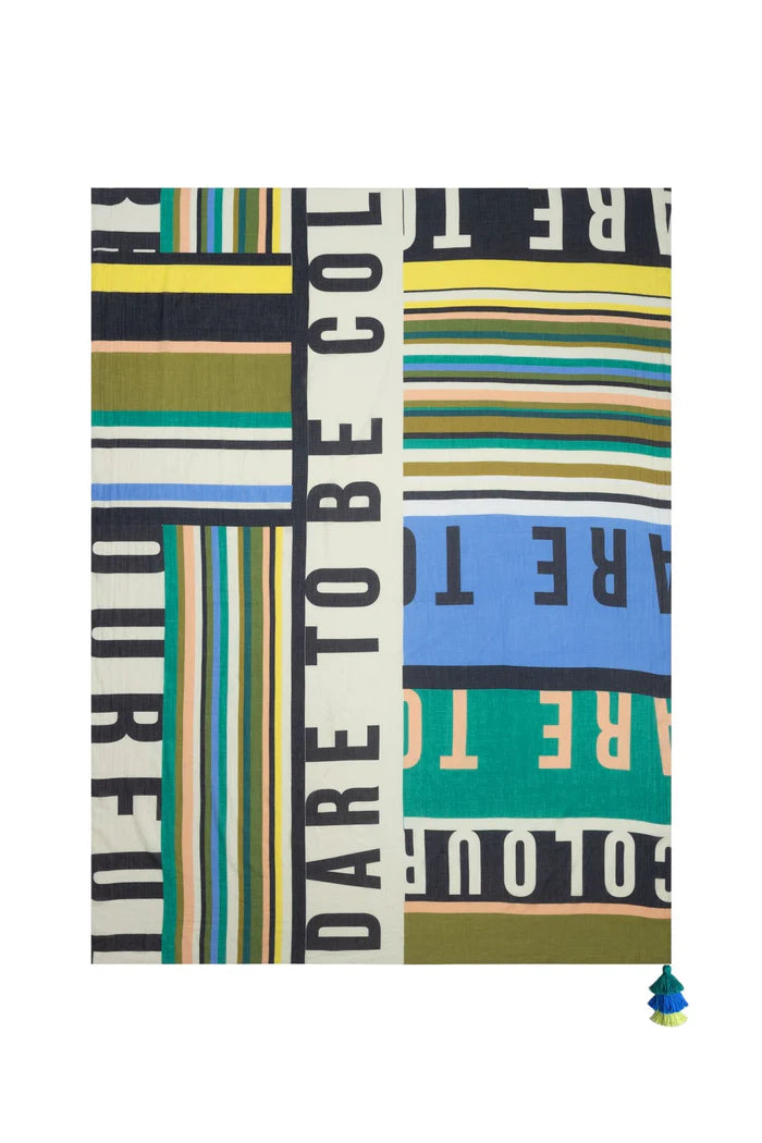 rectangular scarf has a stripey pattern in pastel shades. The scarf is printed with the quote: 'Dare To Be Colourful'